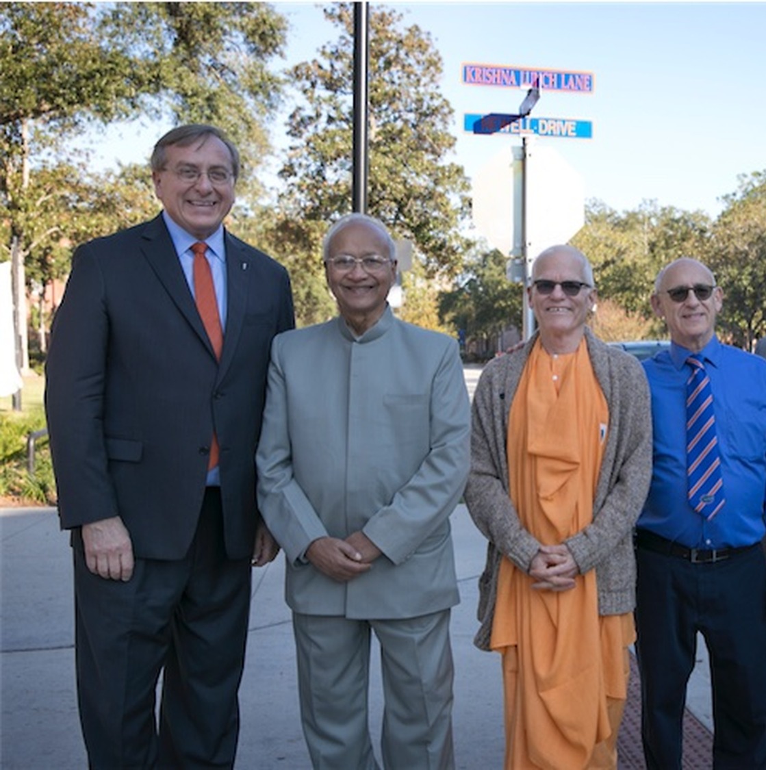 University and Krishna Lunch supporters standing near the Krishna Lunch Lane sign